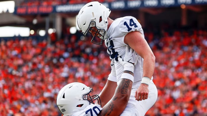 Penn State QB Sean Clifford is lifted by a teammate